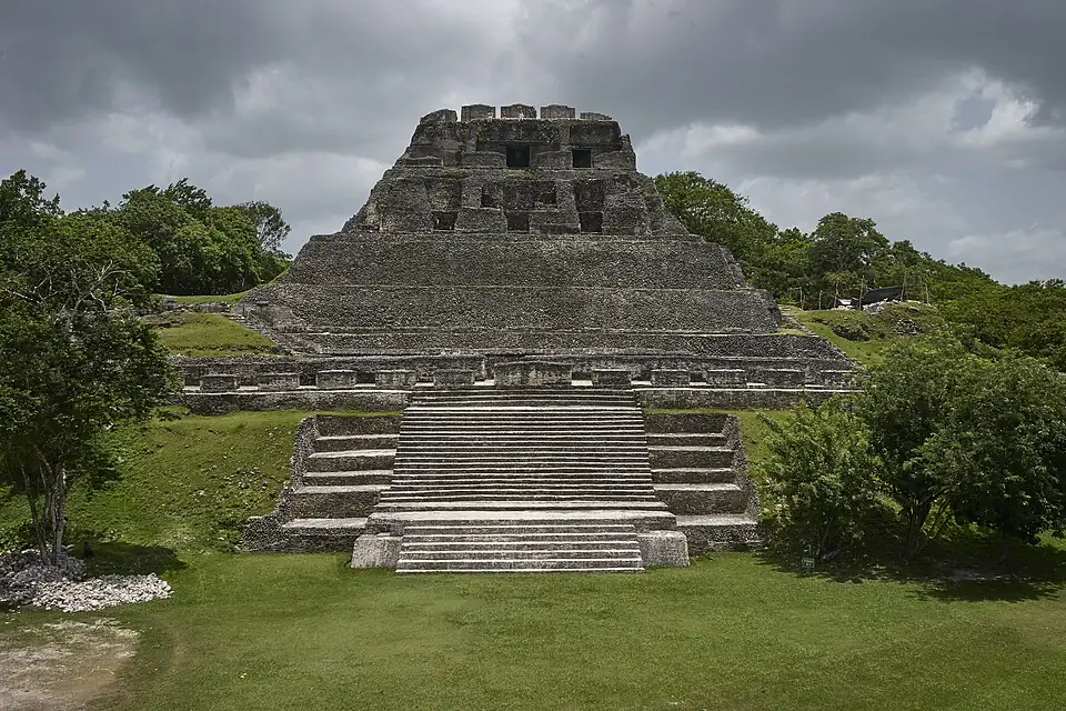The stone stairway and stepped terraces of El Castillo, the largest pyramid at Xunantunich, seen head-on from the plaza.